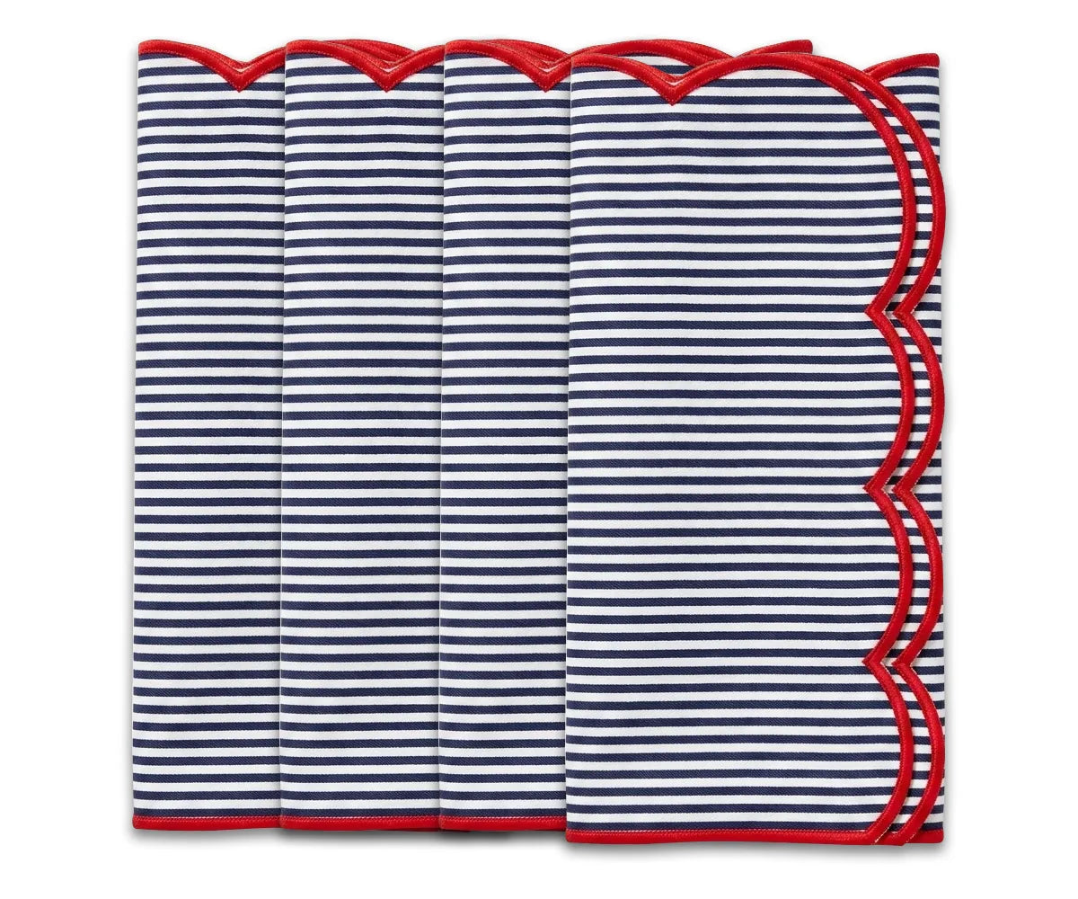 Folded navy blue and white striped napkin with a red scalloped edge on a white background