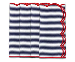 Folded navy blue and white striped napkin with a red scalloped edge on a white background