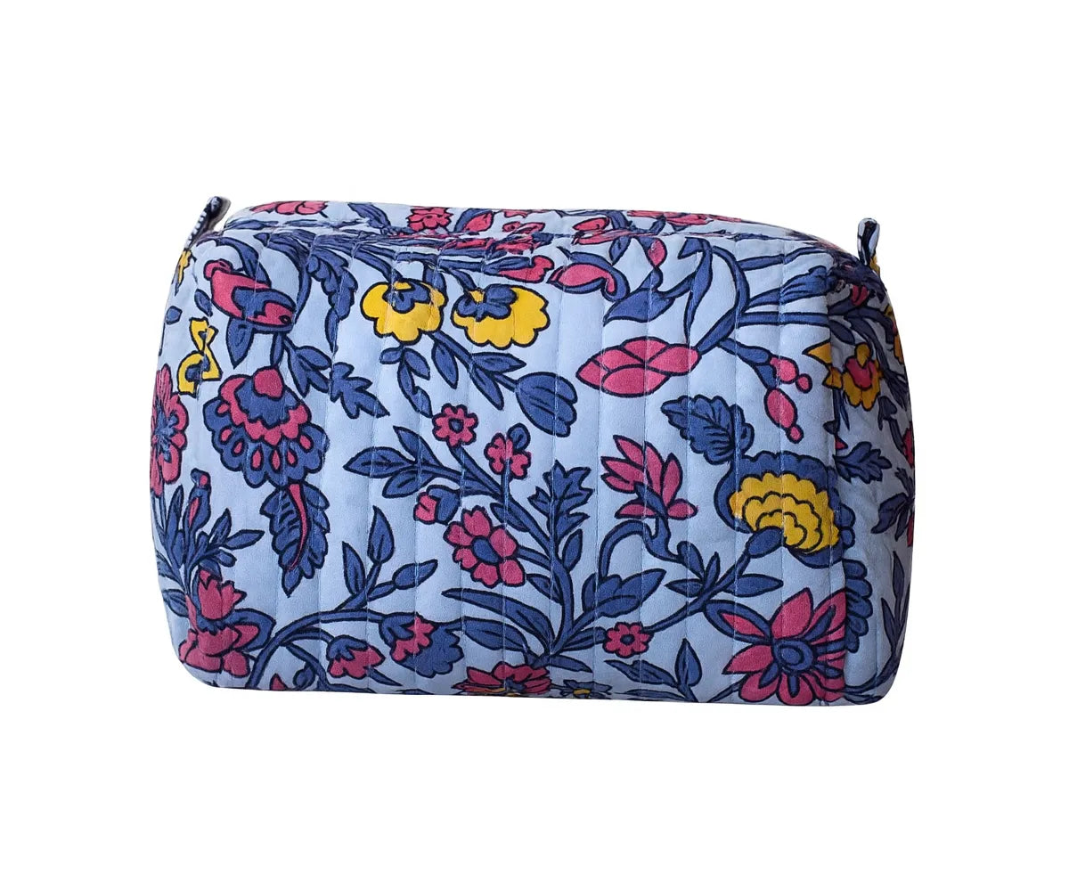 Quilted cotton travel cosmetic bag with zipper closure.