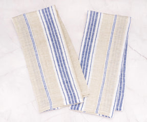 Pair of farmhouse-style striped kitchen towels hanging on a hook in a cozy kitchen