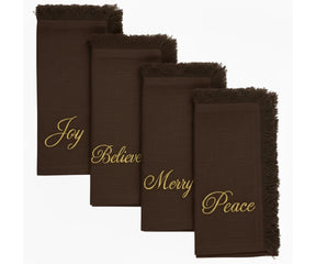 Warm brown embroidered napkins with gold lettering and fringed edges for cozy festive dining