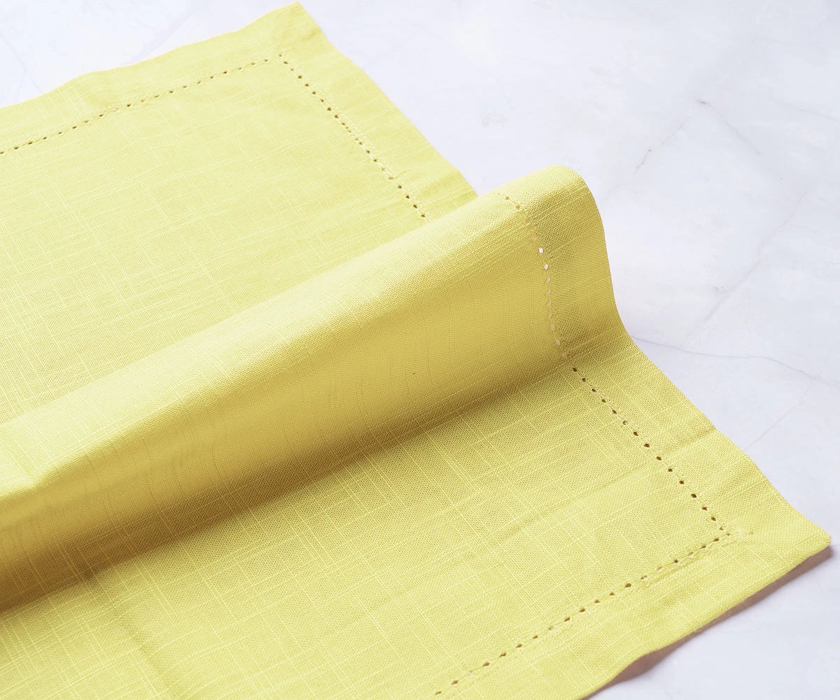 Butter yellow napkin styled with cutlery on a formal table setting