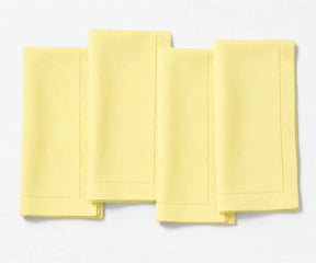 Durable butter yellow linen napkin set with refined hemstitch accents and soft washed finish