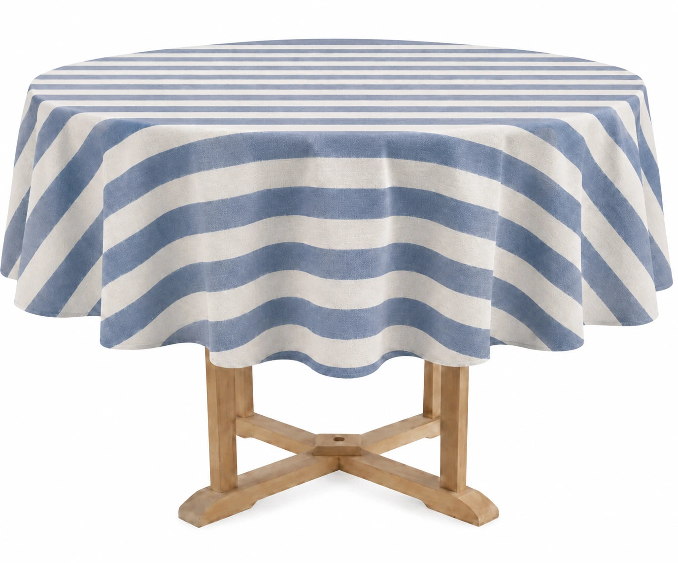 A round table covered with a blue and off-white striped tablecloth, shown on a light wood pedestal table against a plain white background.
