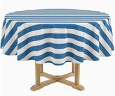 A round table covered with a blue and white striped tablecloth, shown on a light wood pedestal against a plain white background.