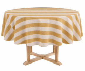 A round table covered with a butter yellow and white striped tablecloth, supported by a light wood pedestal table, isolated on a white background.