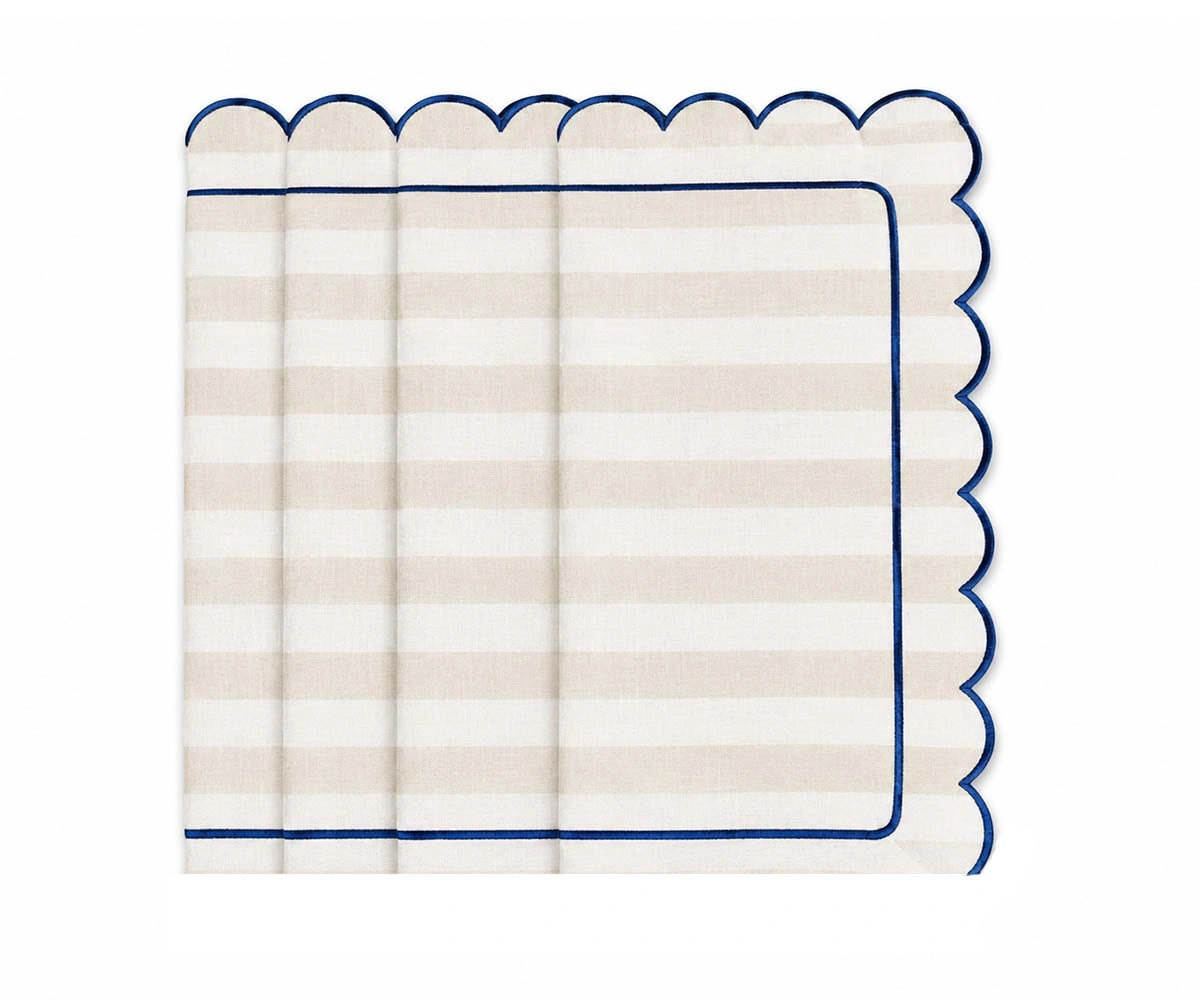Ivory and white striped cloth napkin with scalloped edges and navy trim for elegant neutral table decor