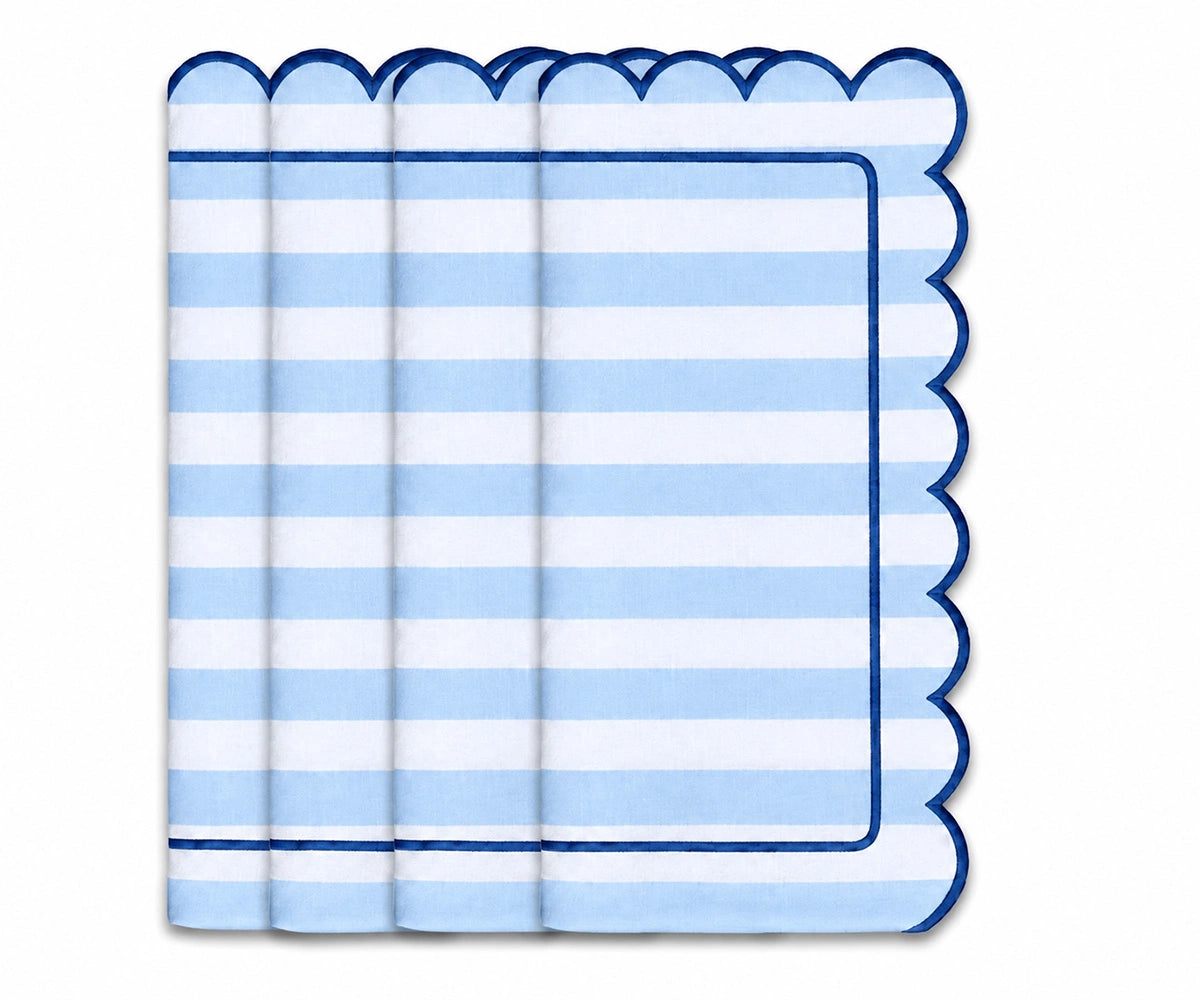 Light blue and white striped cloth napkin with scalloped edges and navy trim for coastal table decor