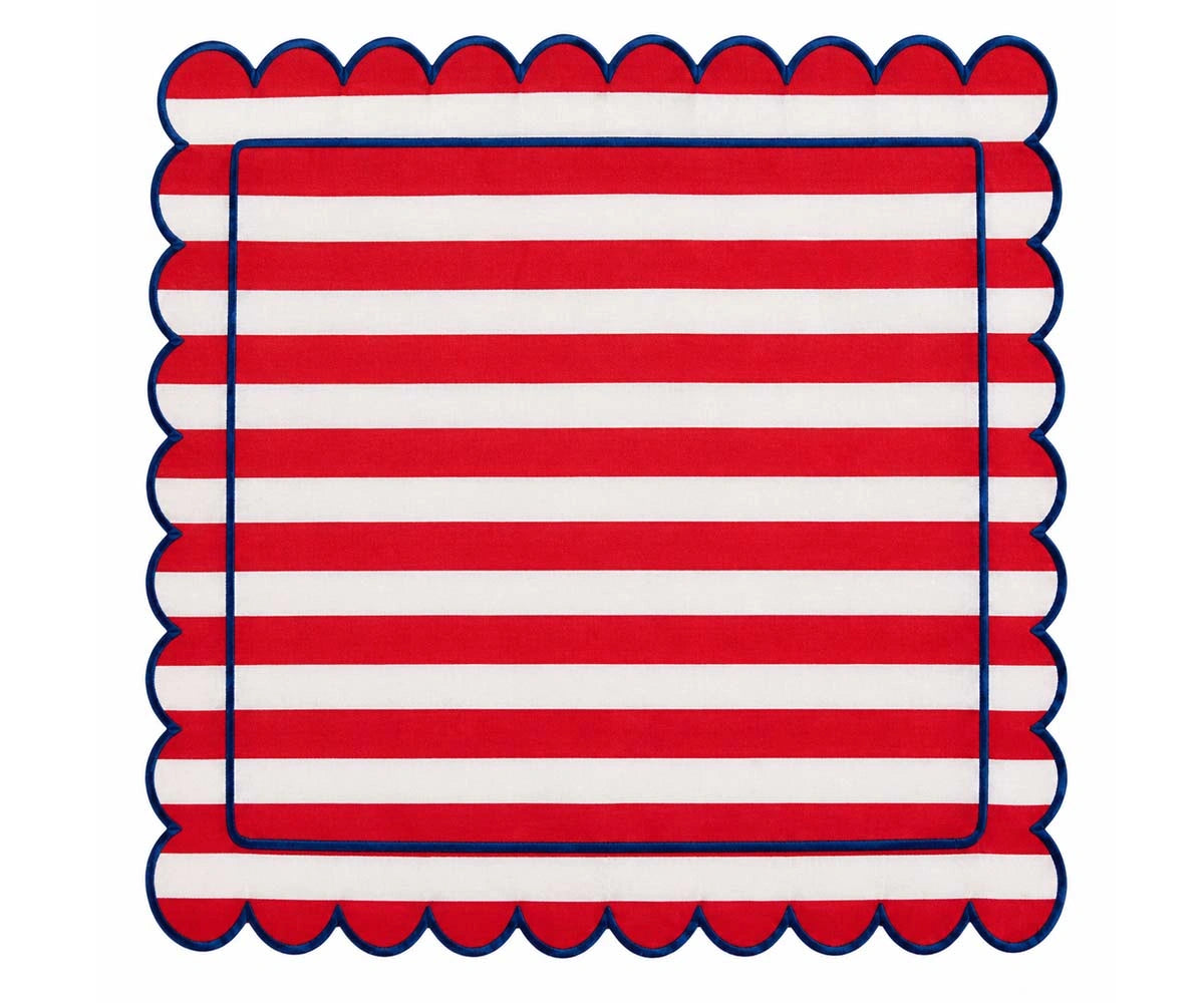 Red and white striped cloth napkin with scalloped edges and navy trim for classic dining table decor