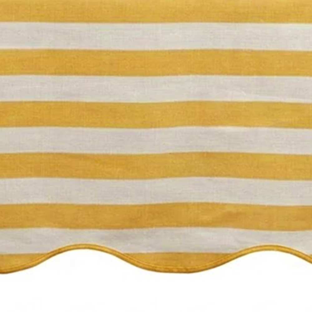 Yellow and white striped awning with scalloped edge