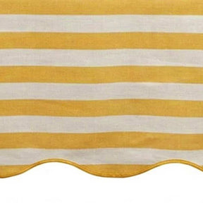 Yellow and white striped awning with scalloped edge