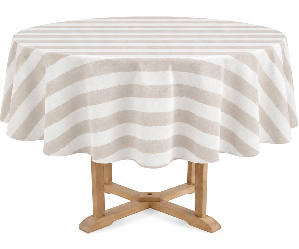 A round table covered with a blush and off-white striped tablecloth, shown on a light wood pedestal table against a plain white background.