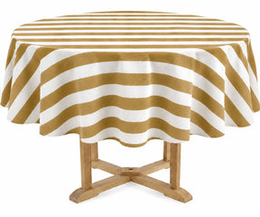 A round table covered with a mustard and off-white striped tablecloth, shown on a light wood pedestal table against a plain white background.