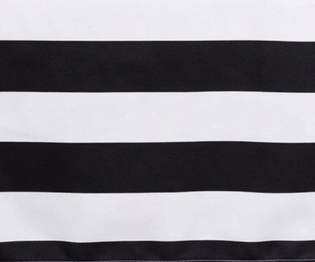 Close-up fabric view of a black and white wide cabana striped cotton  tablecloth.