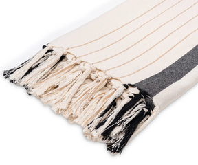Breathable cotton throw with a striped design, finished for a clean and versatile look in any living space