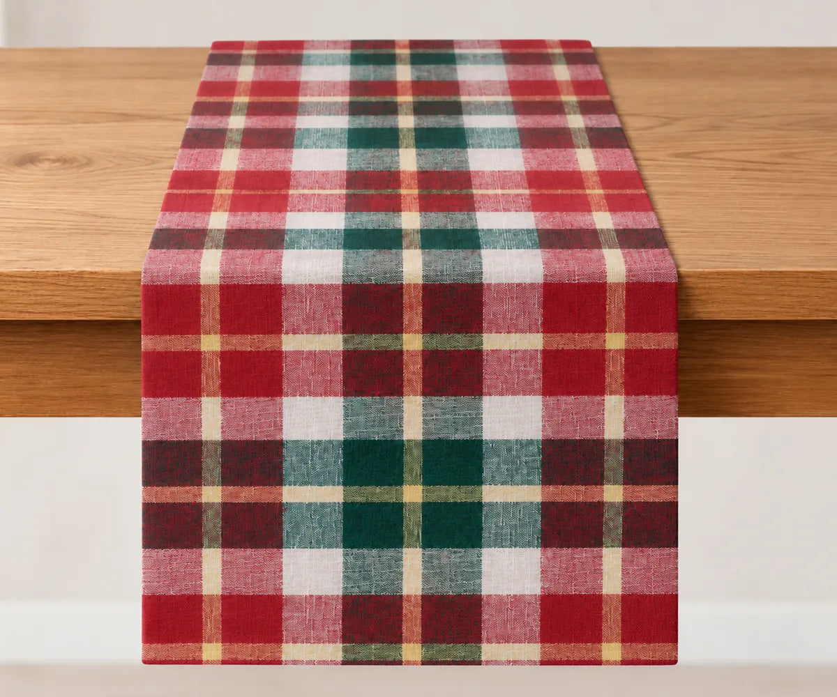 Red green Christmas plaid table runner made from cotton, styled on a dining table for a traditional holiday setting.