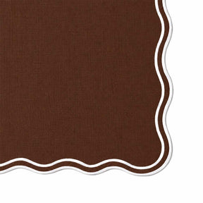 Close-up swatch of a chocolate brown napkin showing woven fabric texture and white scalloped border detail