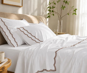 White cotton bedding set with chocolate brown scalloped edge embroidery on pillowcases and flat sheet