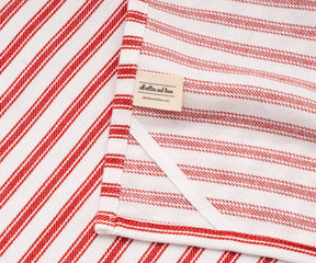 Round table covered with red and white cotton tablecloth