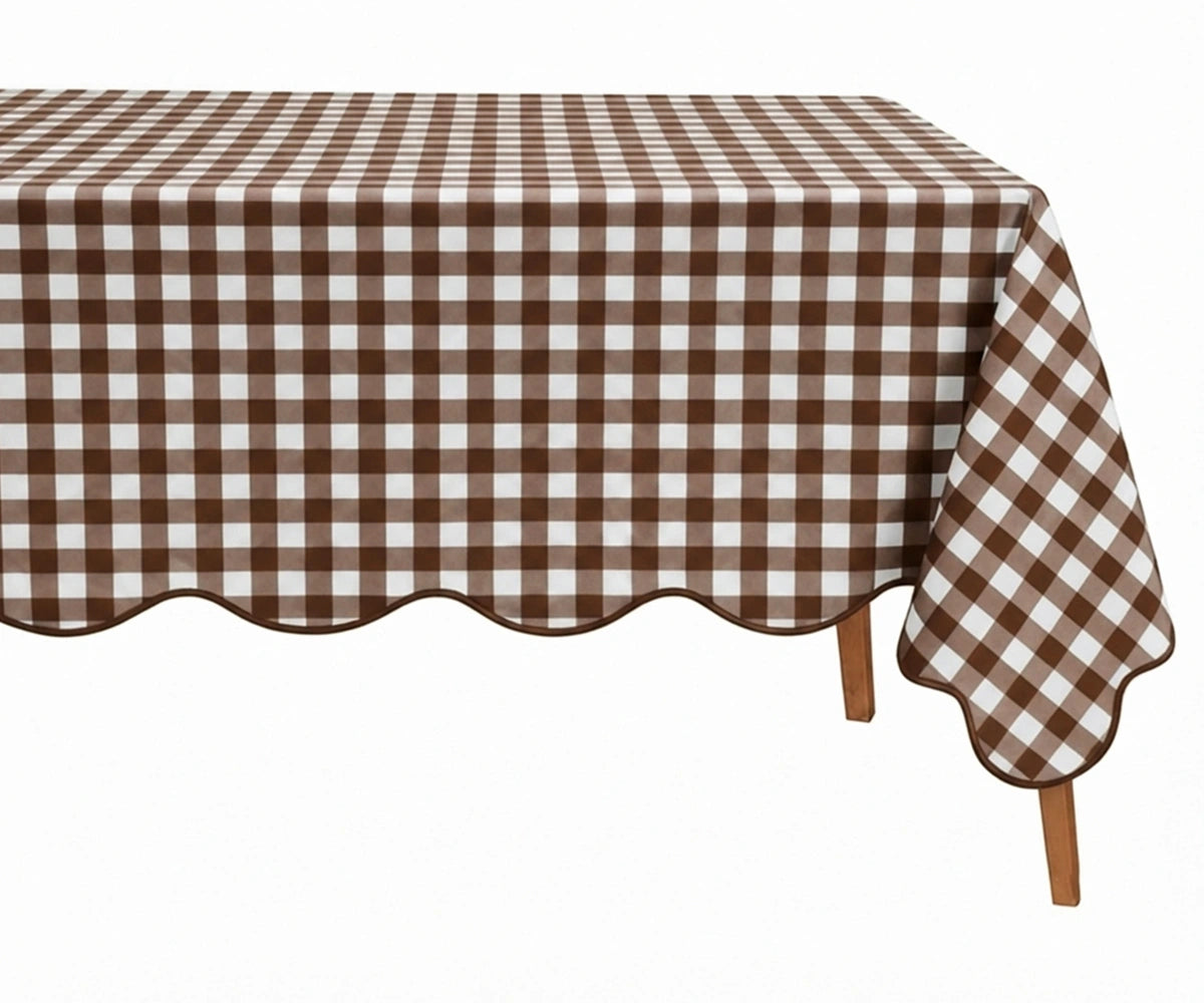 Coffee brown and white checkered cotton tablecloth with a decorative scalloped edge draped over a table.