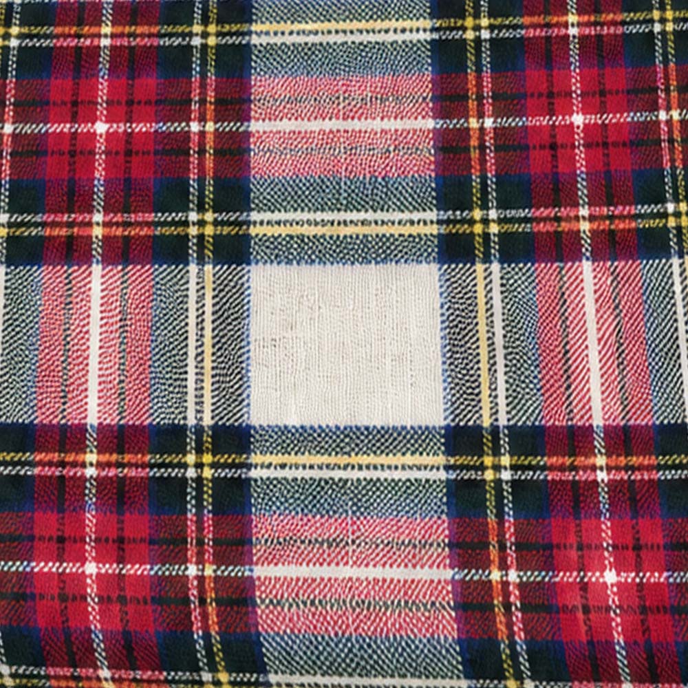 Close-up fabric swatch of classic red, green, navy, and yellow tartan plaid pattern   
