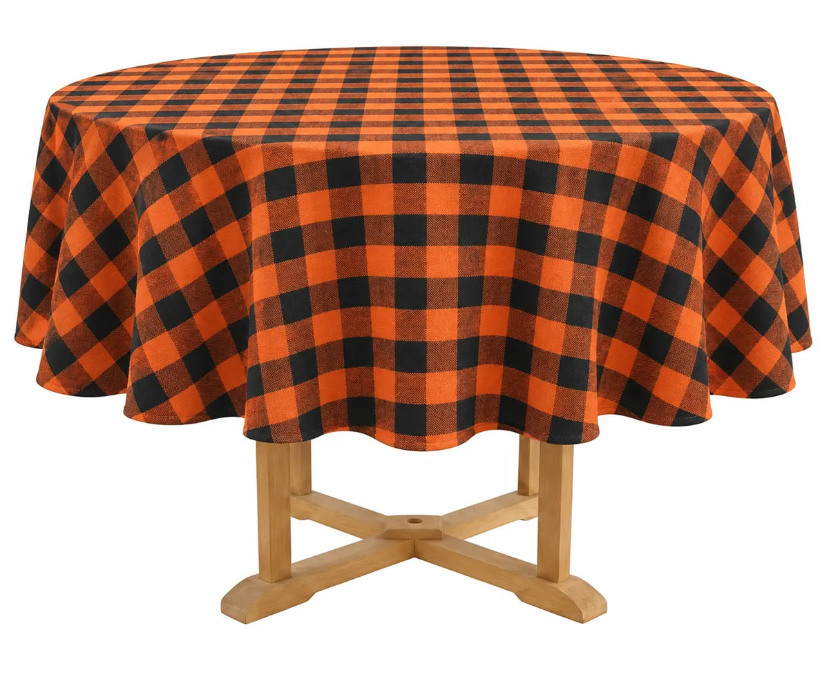 Orange and black plaid round tablecloth made from 100% cotton, styled on a dining table for Halloween dinners, fall gatherings, and seasonal home decor.