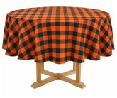 Orange and black plaid round tablecloth made from 100% cotton, styled on a dining table for Halloween dinners, fall gatherings, and seasonal home decor.