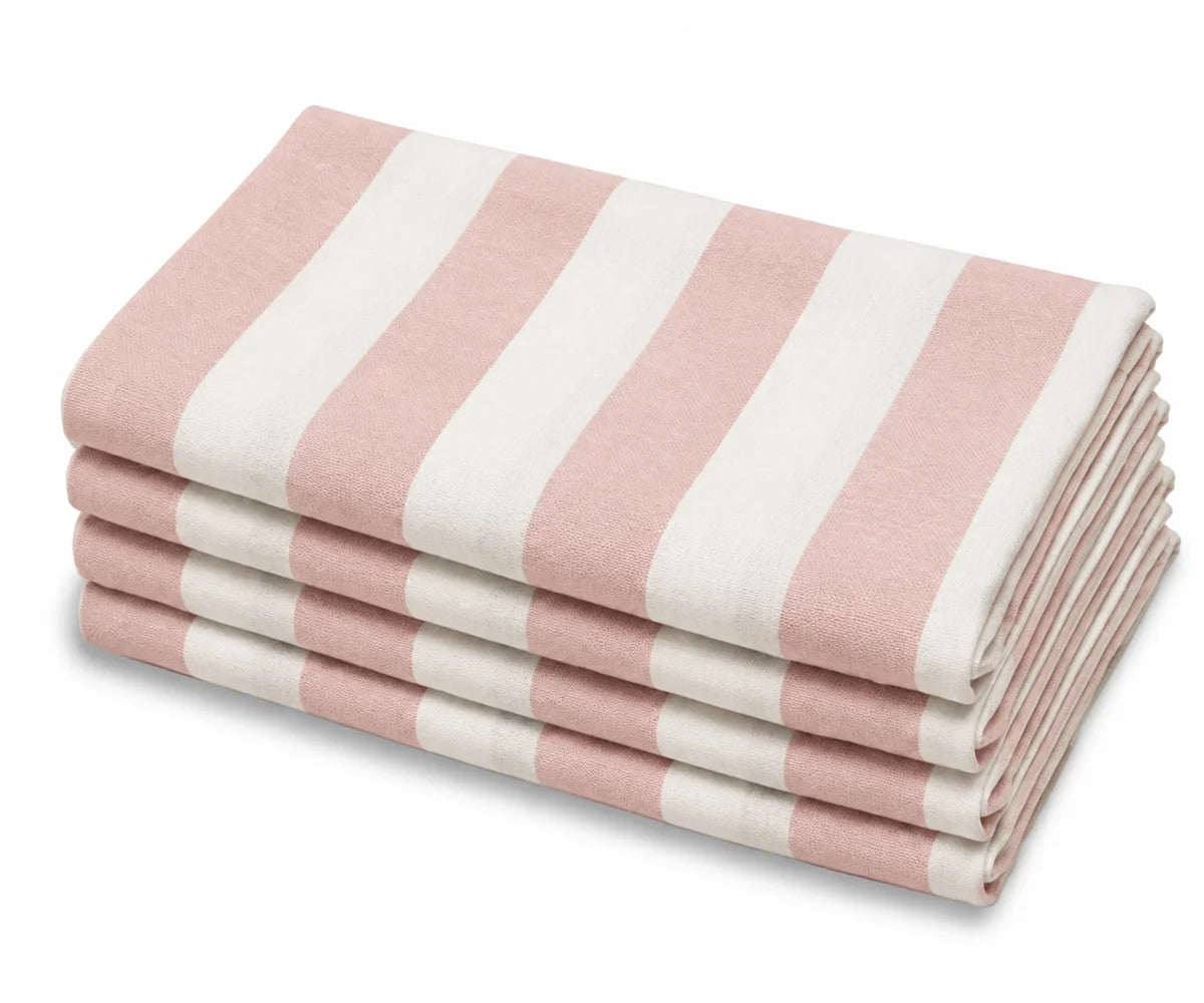 A stack of pink and off-white striped cotton cabana dinner napkins.