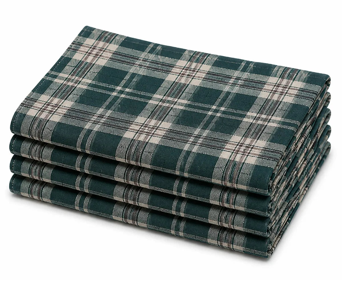 Green and white plaid cotton napkins set on a dining table with rustic dinnerware and seasonal centerpiece