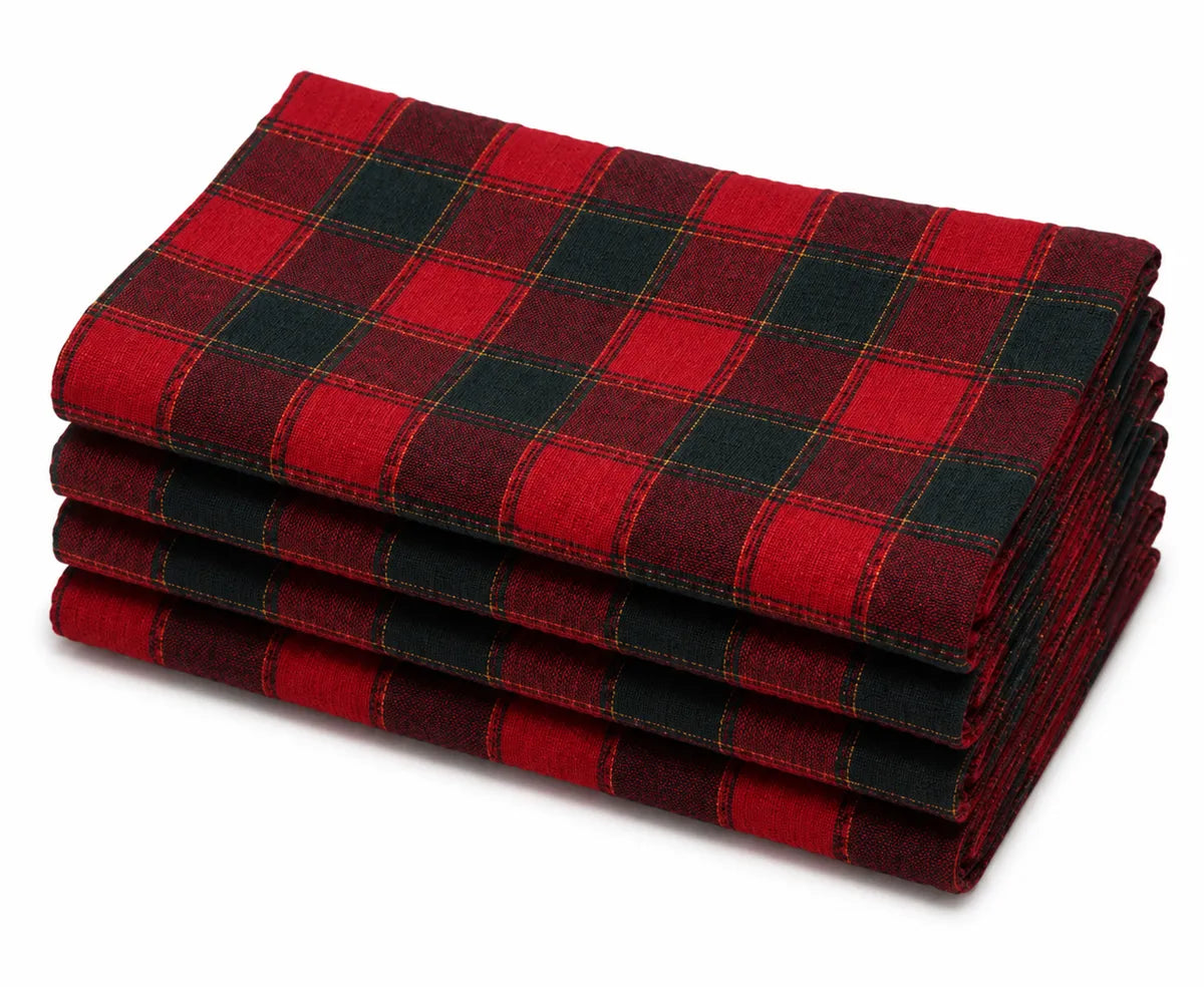 Red black and gold plaid cotton napkins set on a dining table with rustic dinnerware and seasonal centerpiece