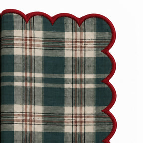 Green plaid Christmas napkin with red scalloped edge and classic checked pattern