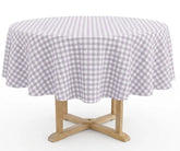 Lavender Round Gingham Tablecloth in 100% cotton featuring a soft lavender and white plaid check pattern, styled on a round dining table for spring gatherings, farmhouse décor, and everyday dining.