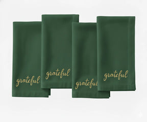 soft green cloth napkin featuring beige stitched “Grateful” message for dining décor.
