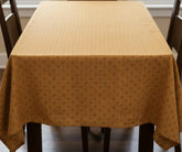 Coral printed 100% cotton tablecloth draped on rectangular dining table