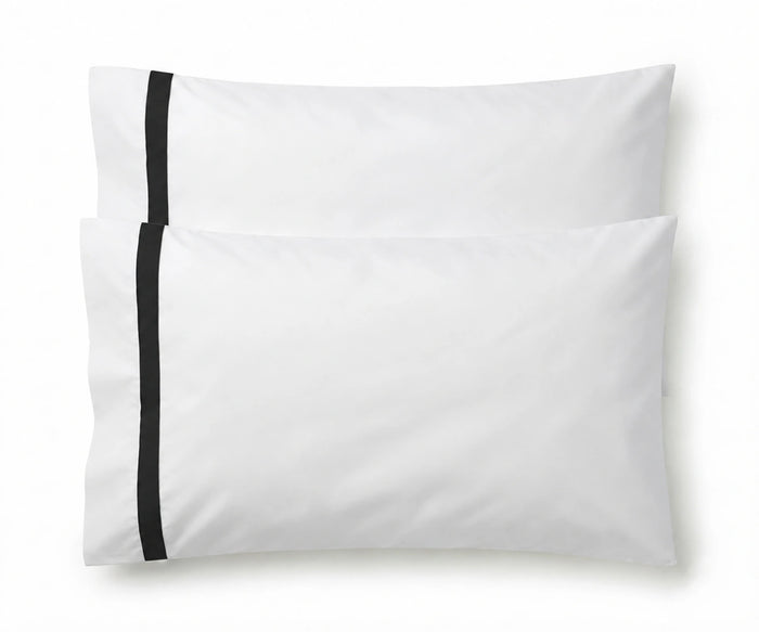 Pair of white cotton pillowcases featuring a single black embroidered accent border line.