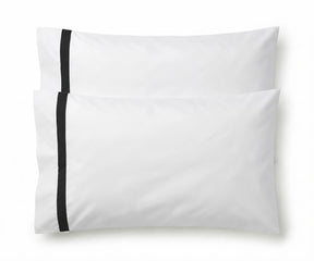 Pair of white cotton pillowcases featuring a single black embroidered accent border line.