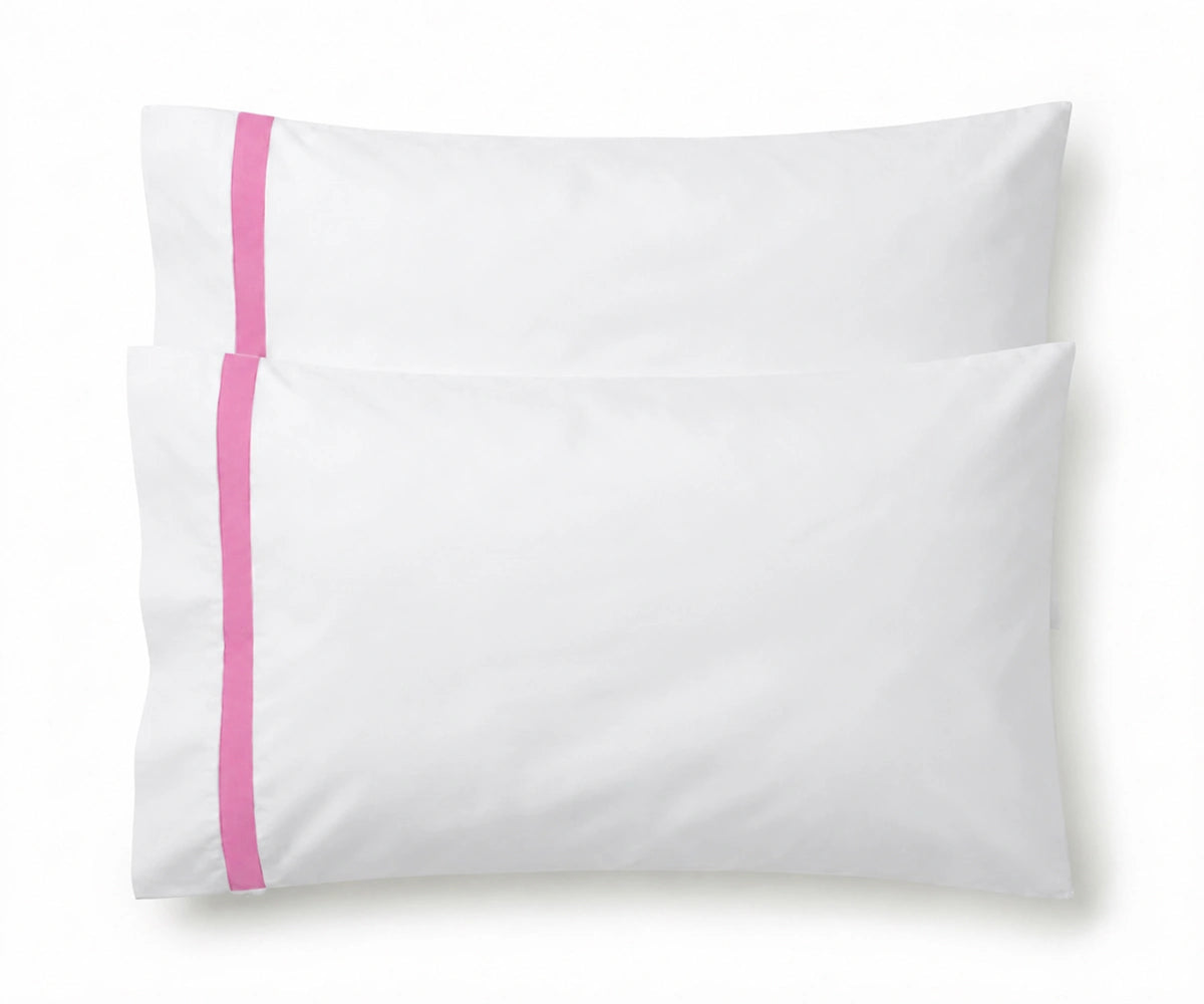 Pair of white cotton pillowcases featuring a single pink embroidered accent border line.