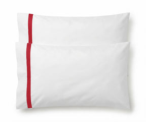 Pair of white cotton pillowcases featuring a single red embroidered accent border line.