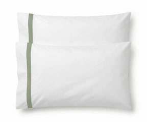 Pair of white cotton pillowcases featuring a single sage green embroidered accent border line.
