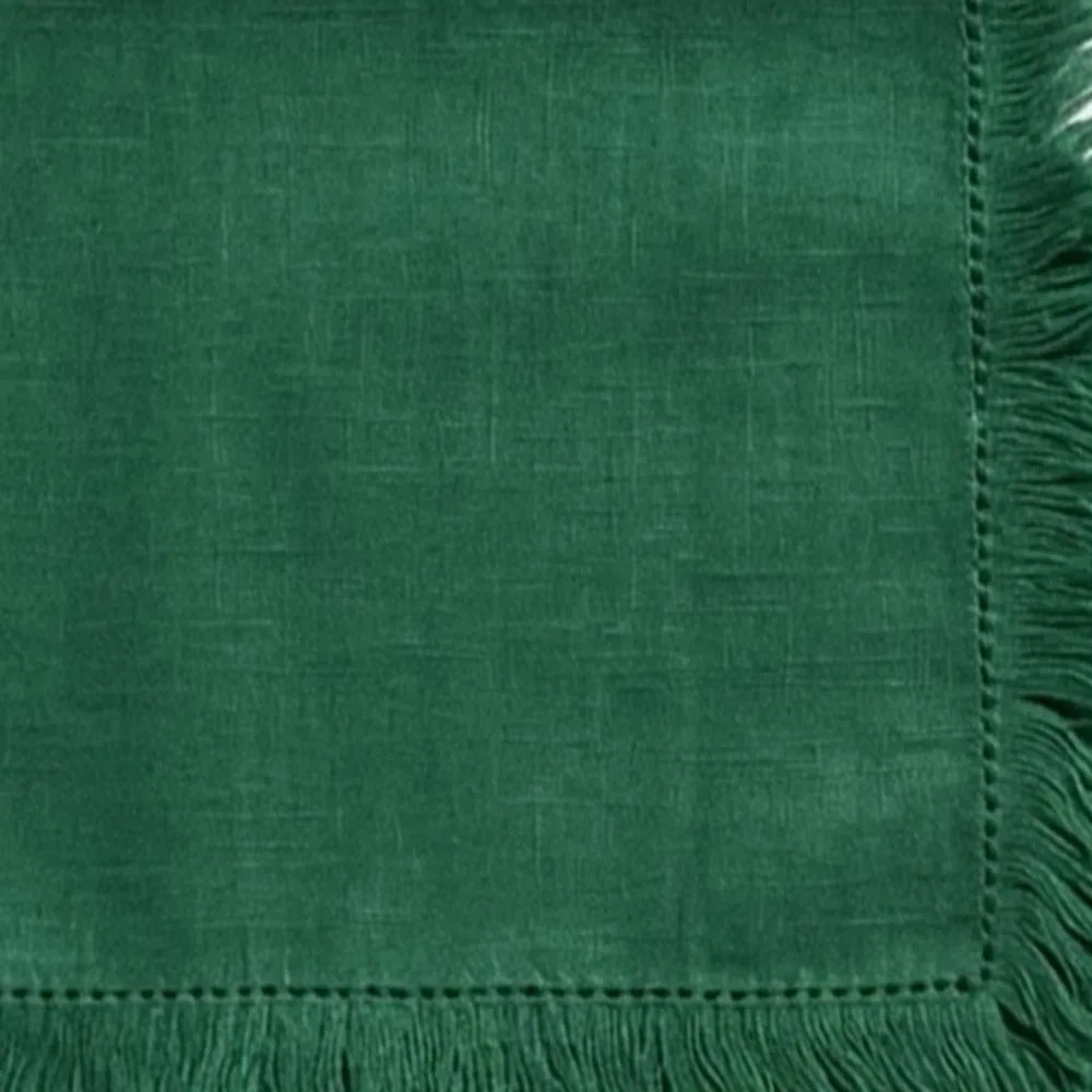Decorative cotton cloth napkins with fringe detailing, designed for stylish table presentations and sustainable dining setups.