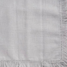 Soft cotton fabric napkins with fringe trim, reusable table linens designed for effortless table styling.