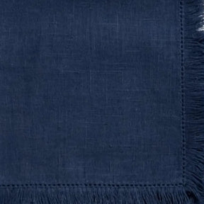 Reusable cotton table napkins featuring decorative fringe edges for a relaxed and elegant dining presentation.