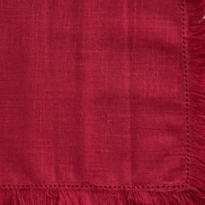 Set of reusable cotton table napkins with fringe detailing, perfect for creating a refined and sustainable dining setup.