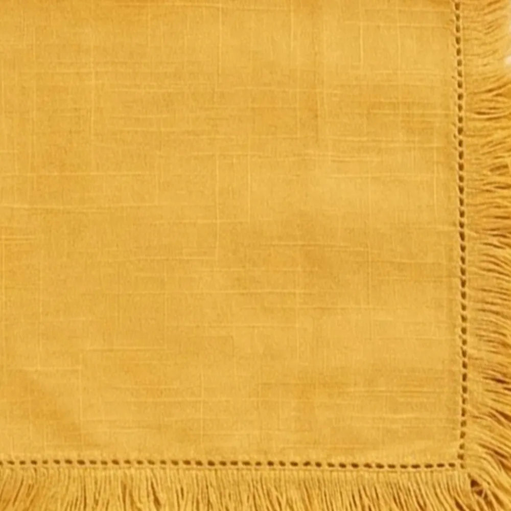 Natural cotton fabric napkins with fringe trim, reusable table linens for casual meals and special events.