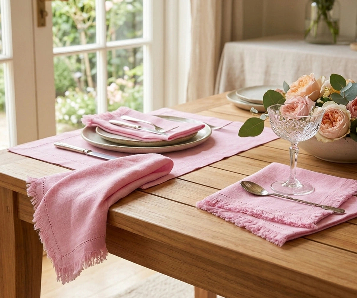 Blush pink cotton fringe napkins with elegant frayed edges, reusable cloth dinner napkins for wedding receptions, bridal showers, baby showers, romantic tablescapes, farmhouse dining décor, and sustainable entertaining.