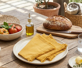 Yellow cotton fringe napkins with decorative frayed trim, reusable fabric dinner napkins for summer parties, brunch table settings, wedding celebrations, cheerful farmhouse décor, and eco-friendly entertaining.
