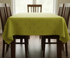 Green leaf printed cotton tablecloth draped on rectangular dining table