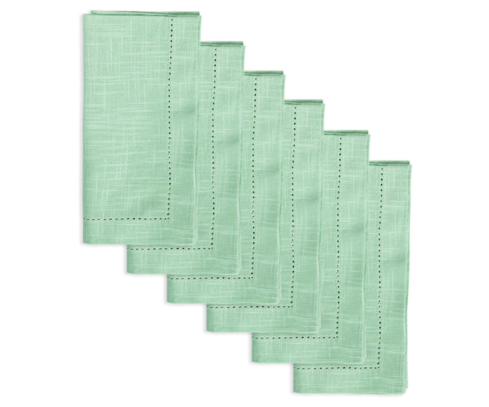 Set of six green napkins with hemstitching on a white background