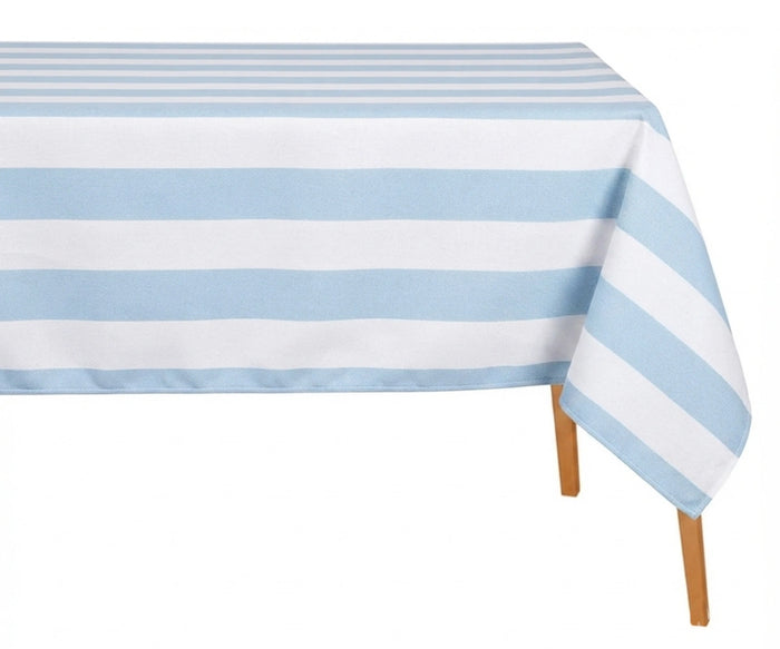 Light blue and white wide cabana striped cotton linen tablecloth with straight edges draped over a dining table.