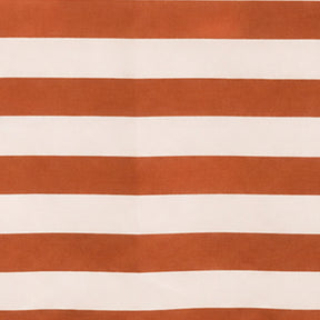 Terracotta striped cotton linen tablecloth with soft woven texture, creating a cozy and elegant dining room setting.